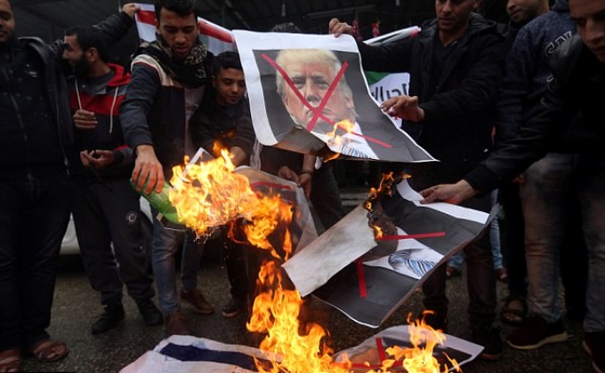 Furious Palestinians burn American flags and promise more 'days of rage' after Trump says Jerusalem IS Israel's capital